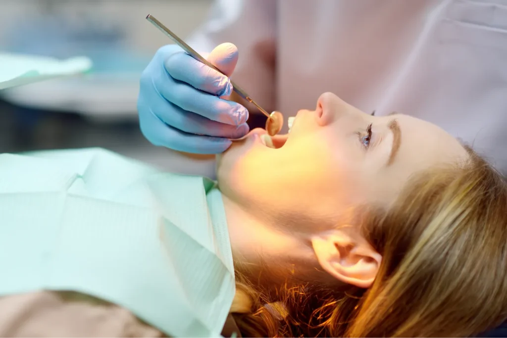 Close-up of a dentist examining a patient's teeth during a dental checkup.