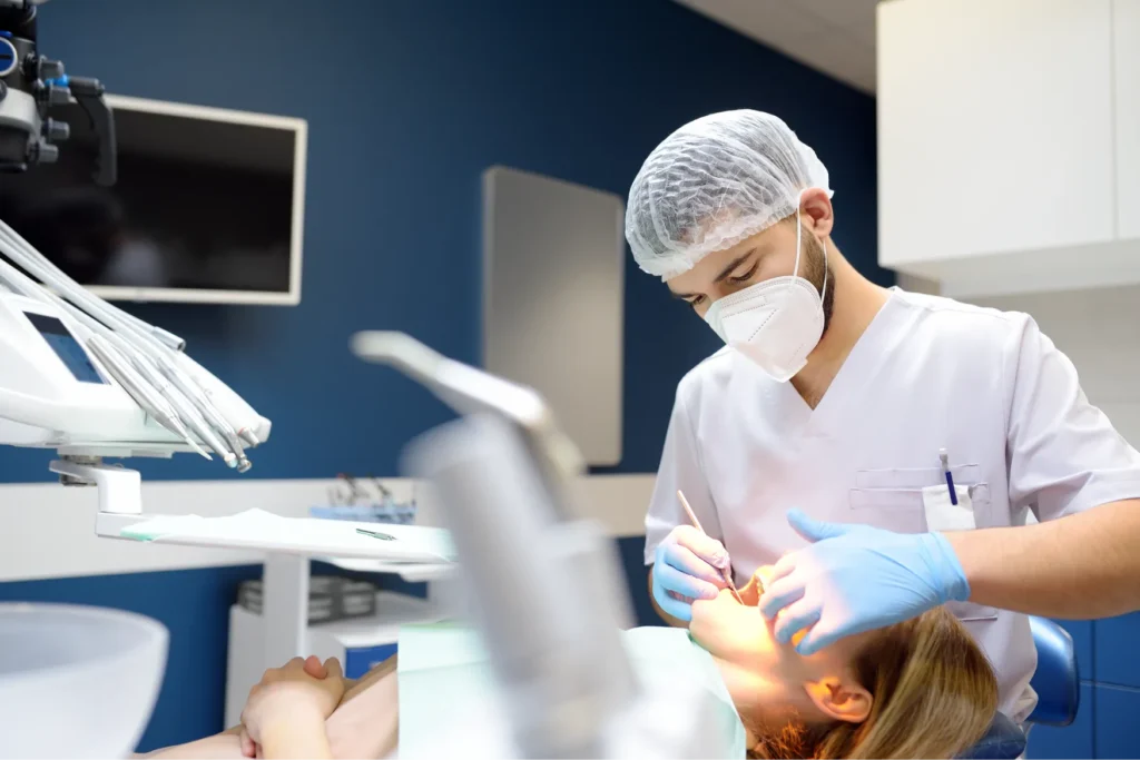Dentist performing a dental procedure on a patient.