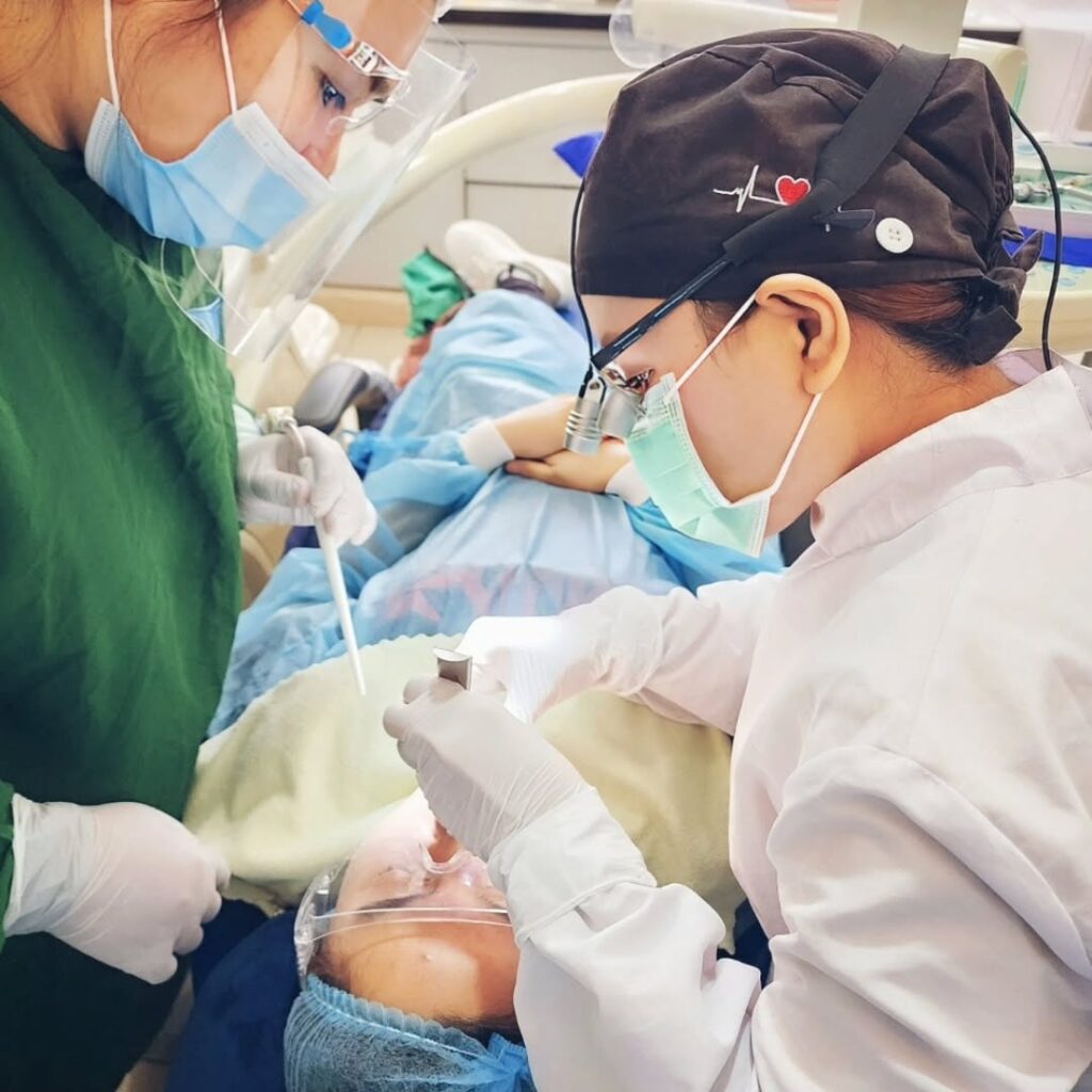 Dental professionals meticulously working on a patient's tooth restoration, showcasing precision and expertise.