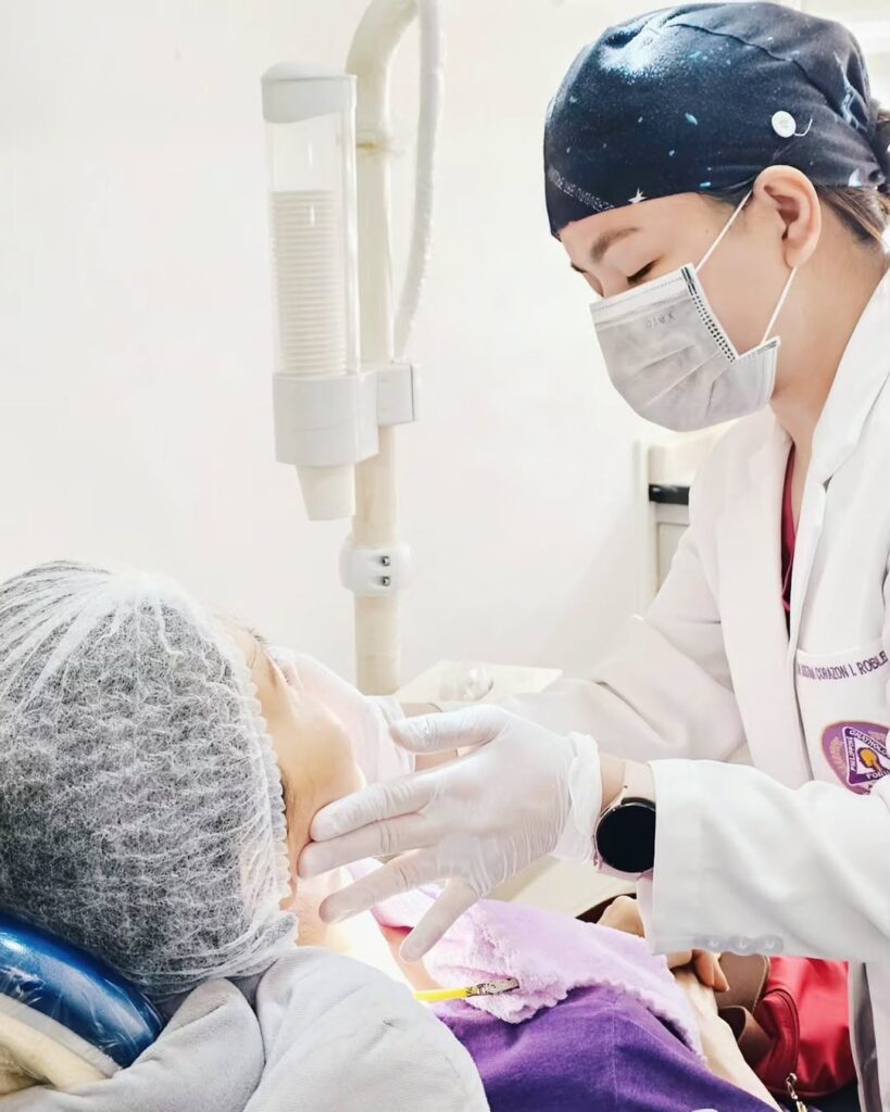 A dentist examining a patient's jaw, illustrating TMJ therapy to relieve jaw pain and restore comfort.